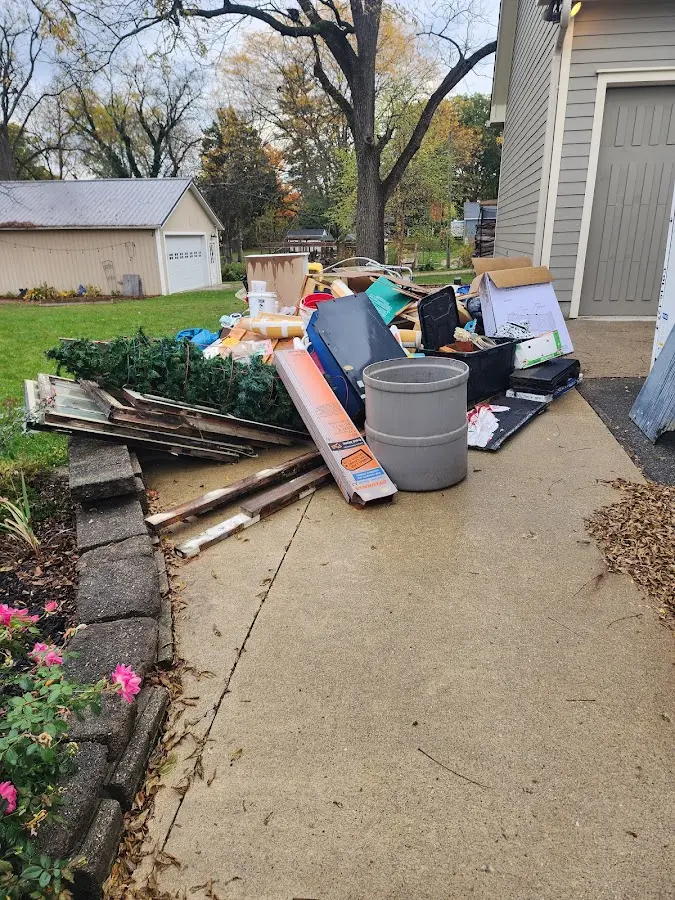 Dumpster being loaded with debris for Estate Cleanout Dumpster Rental in Gregg